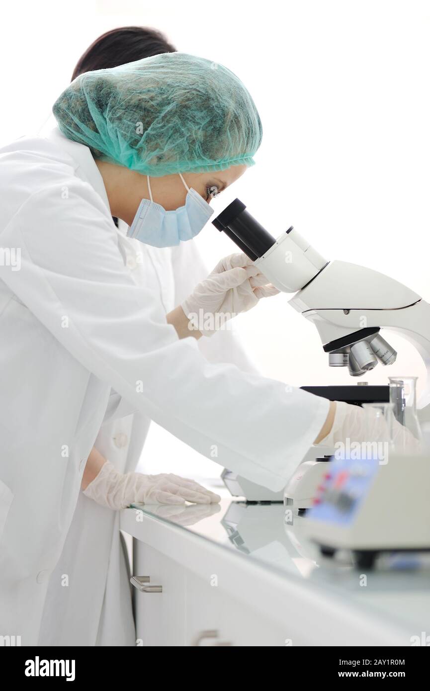Working in lab with microscope Stock Photo