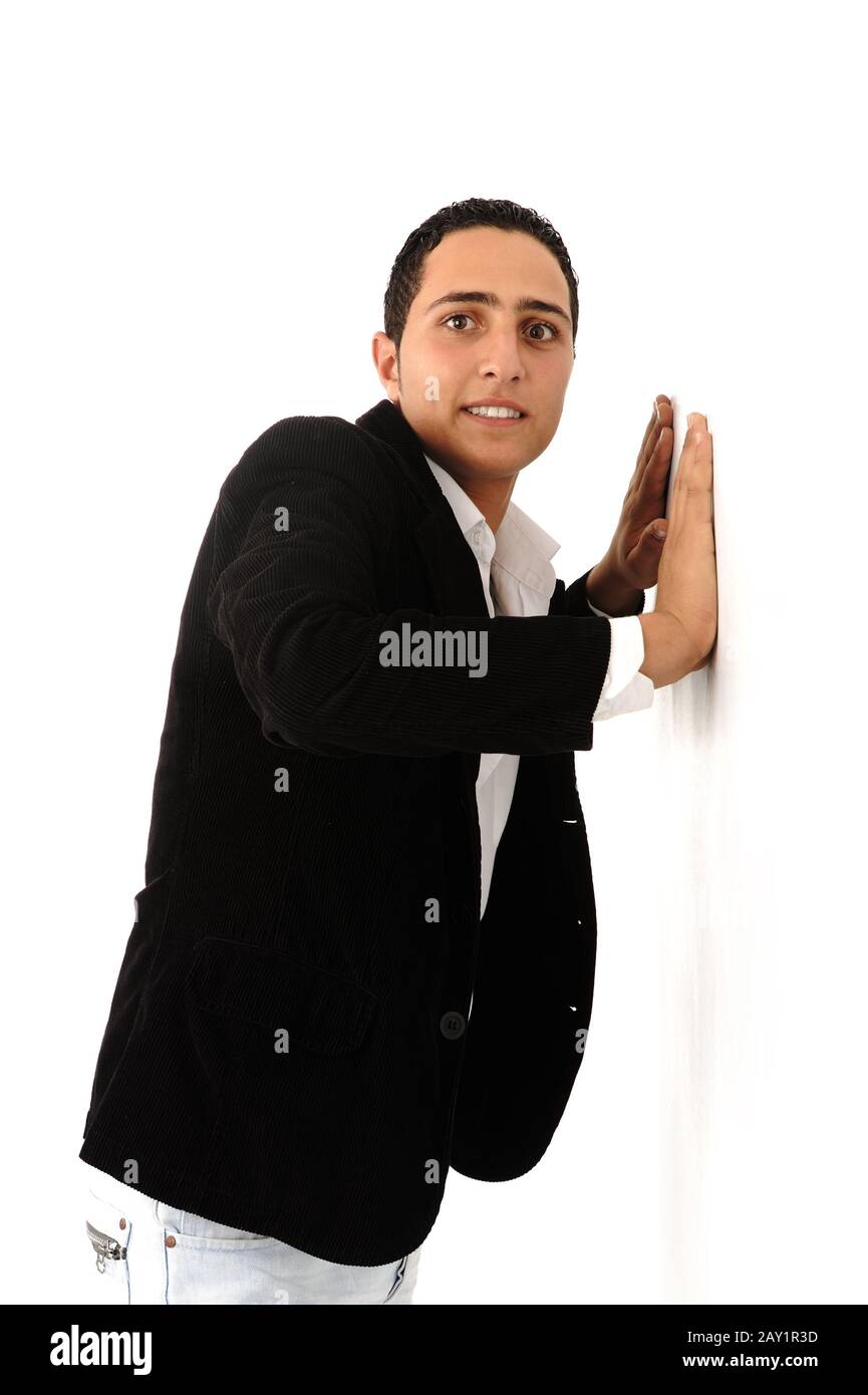 Arabic student leaning against the wall isolated Stock Photo