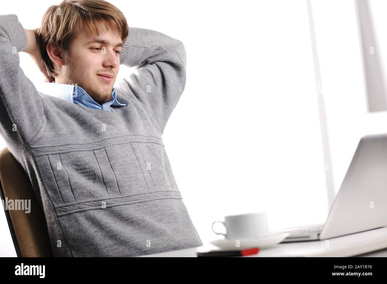 Relaxed young man in office Stock Photo