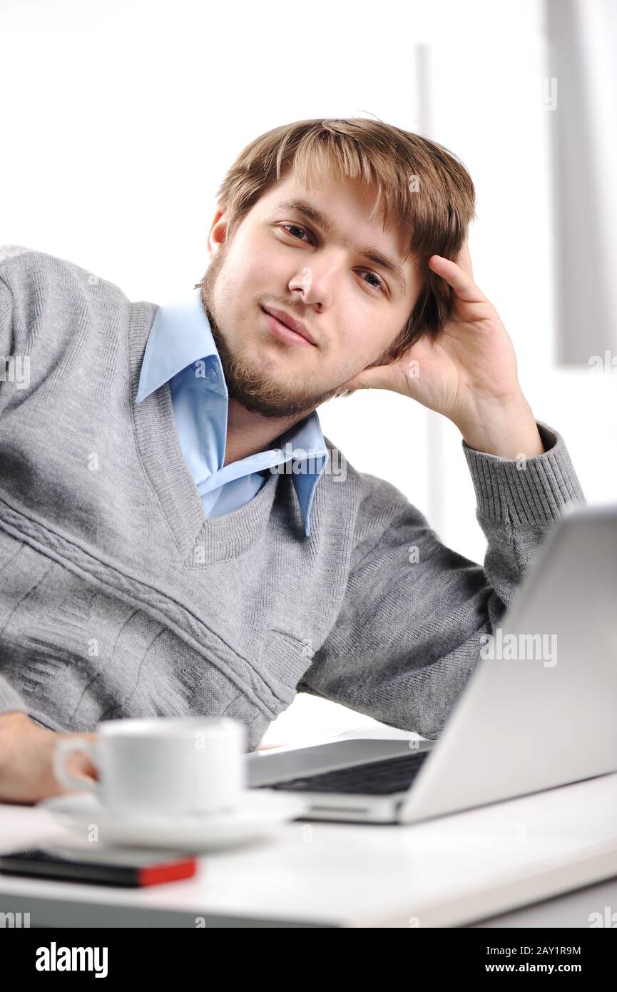 Relaxed young man in office Stock Photo