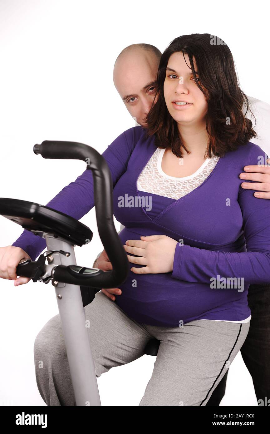 Pregnant woman on treadmill with her husband Stock Photo Alamy