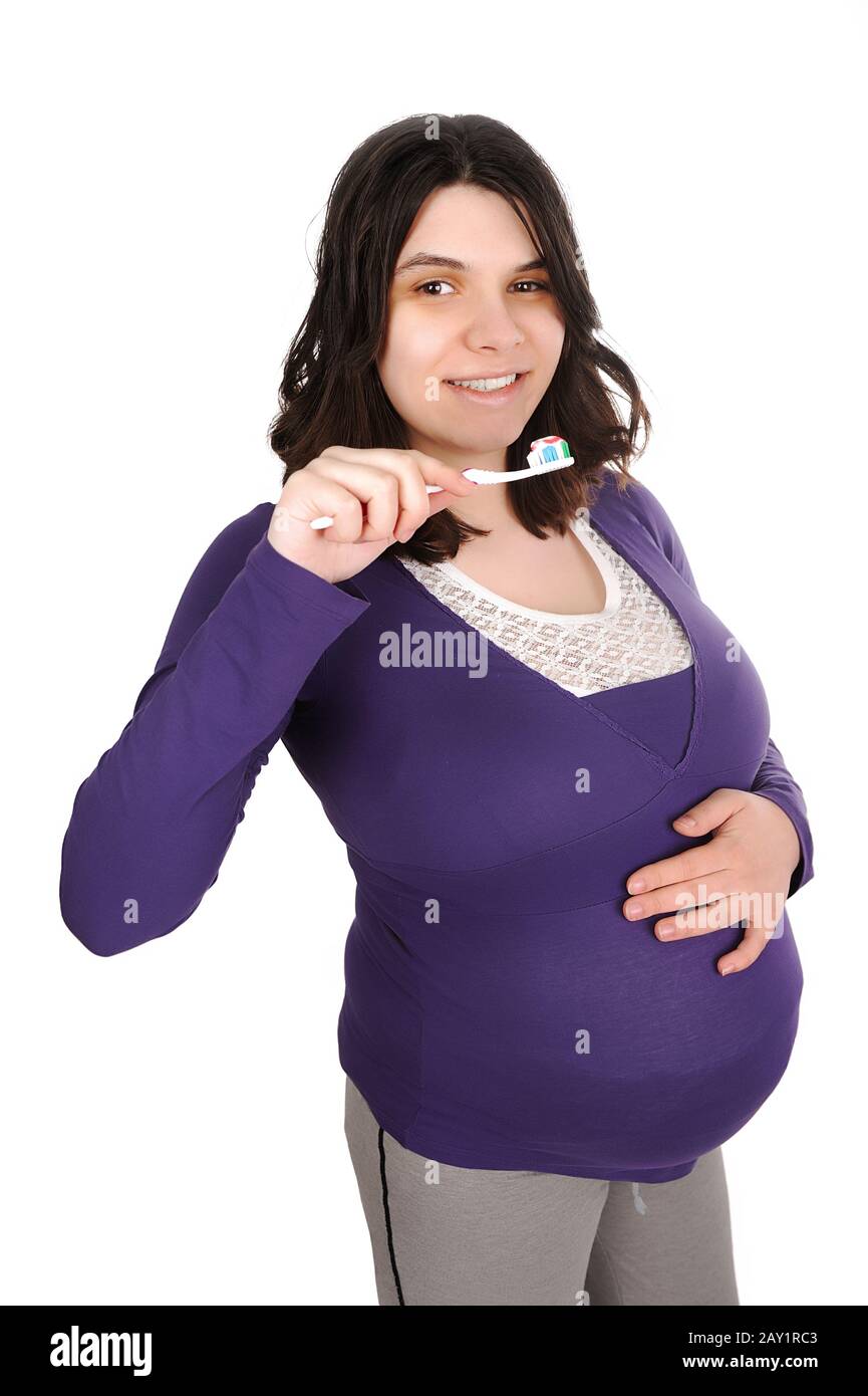 Pregnant woman brushing her teeth Stock Photo Alamy