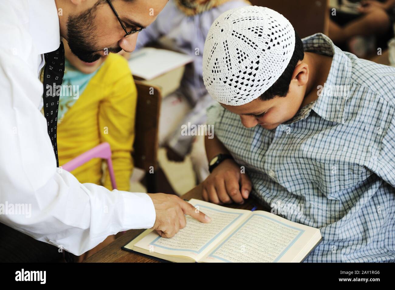 Arabic middle eastern students at school reading Koran Stock Photo