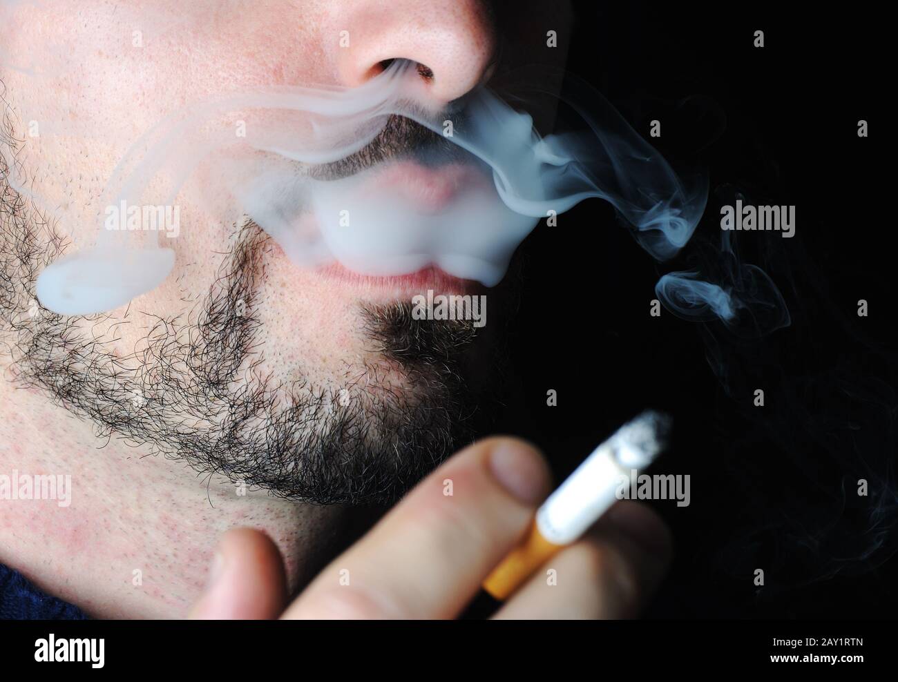 Man smoking in dark with visible smoke Stock Photo Alamy