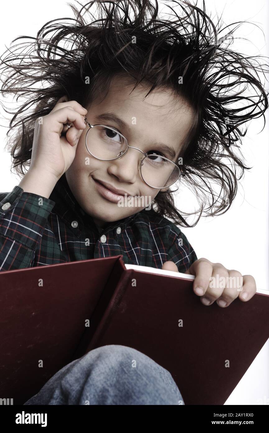 Smart nerd kid with glasses and funny hair writing Stock Photo Alamy
