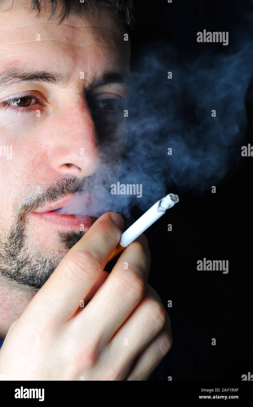 Man smoking in dark Stock Photo - Alamy