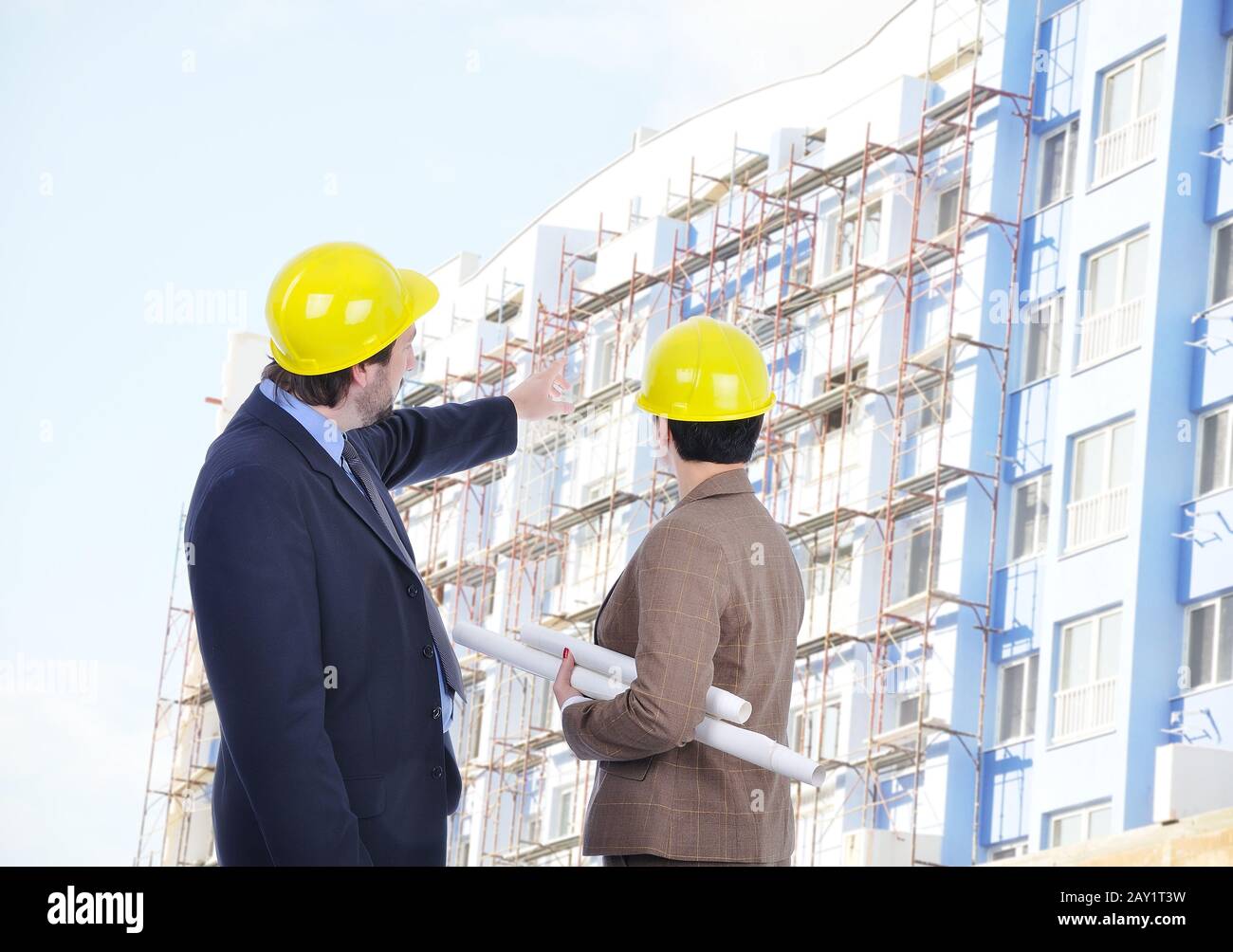 Two young engineers with blueprints Stock Photo