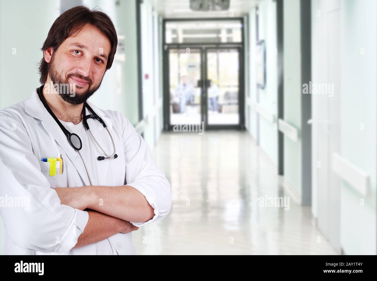 Young positive doctor on his workplace Stock Photo