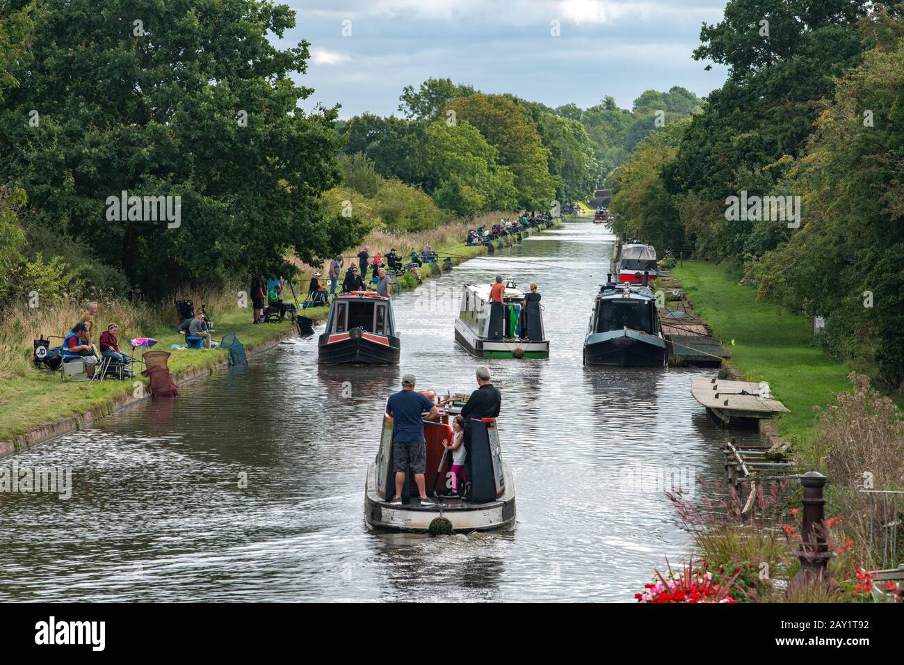 Narrowboats navigating around the competitors in a canal competition on the Shropshire Union Canal in Staffs. Stock Photo