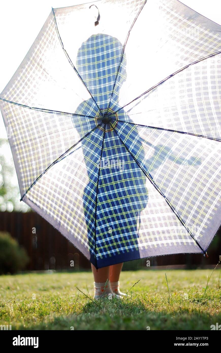 Little boy holding umbrella against the sun Stock Photo Alamy