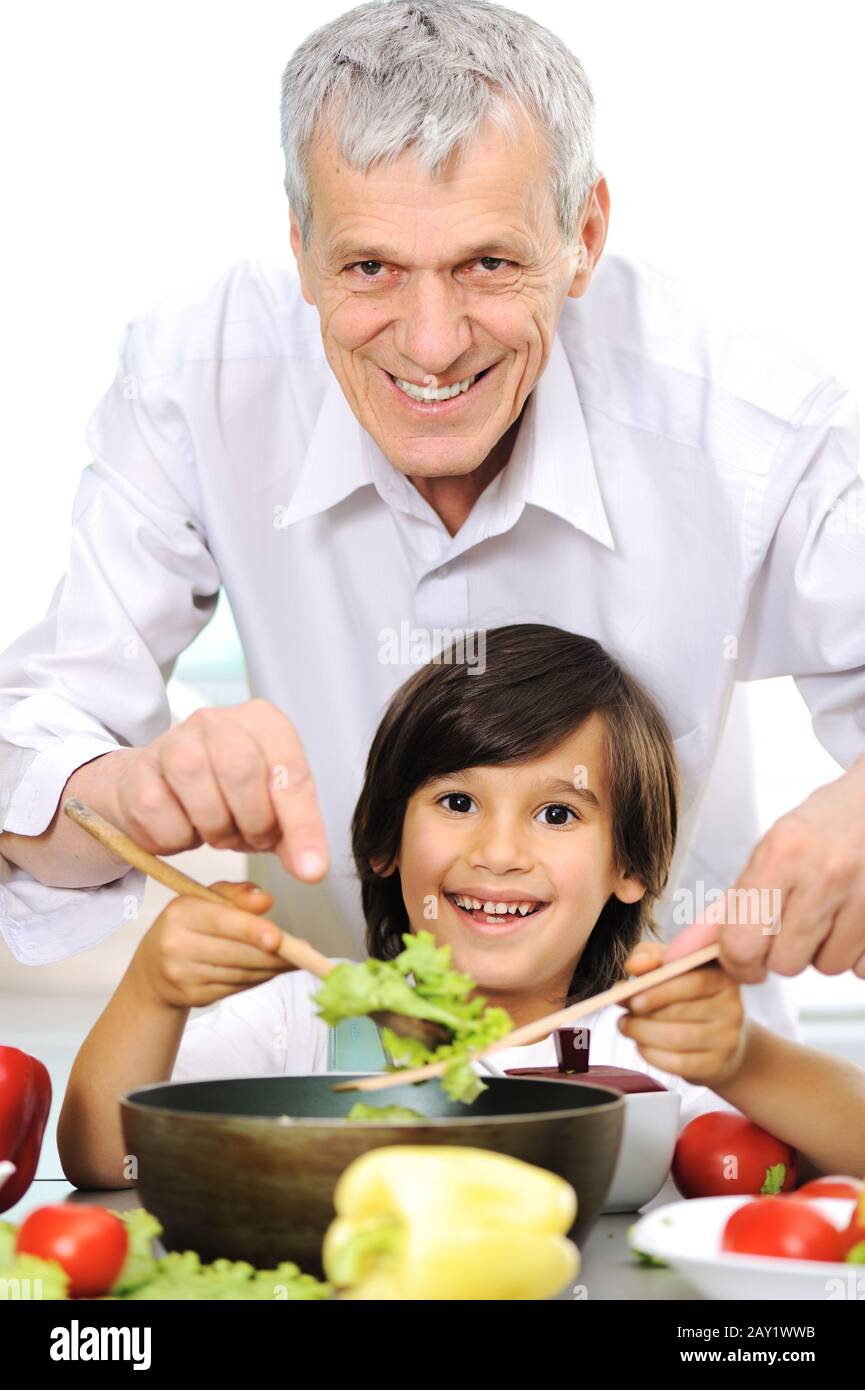 Grandfather and little boy in kitchen cooking together Stock Photo - Alamy
