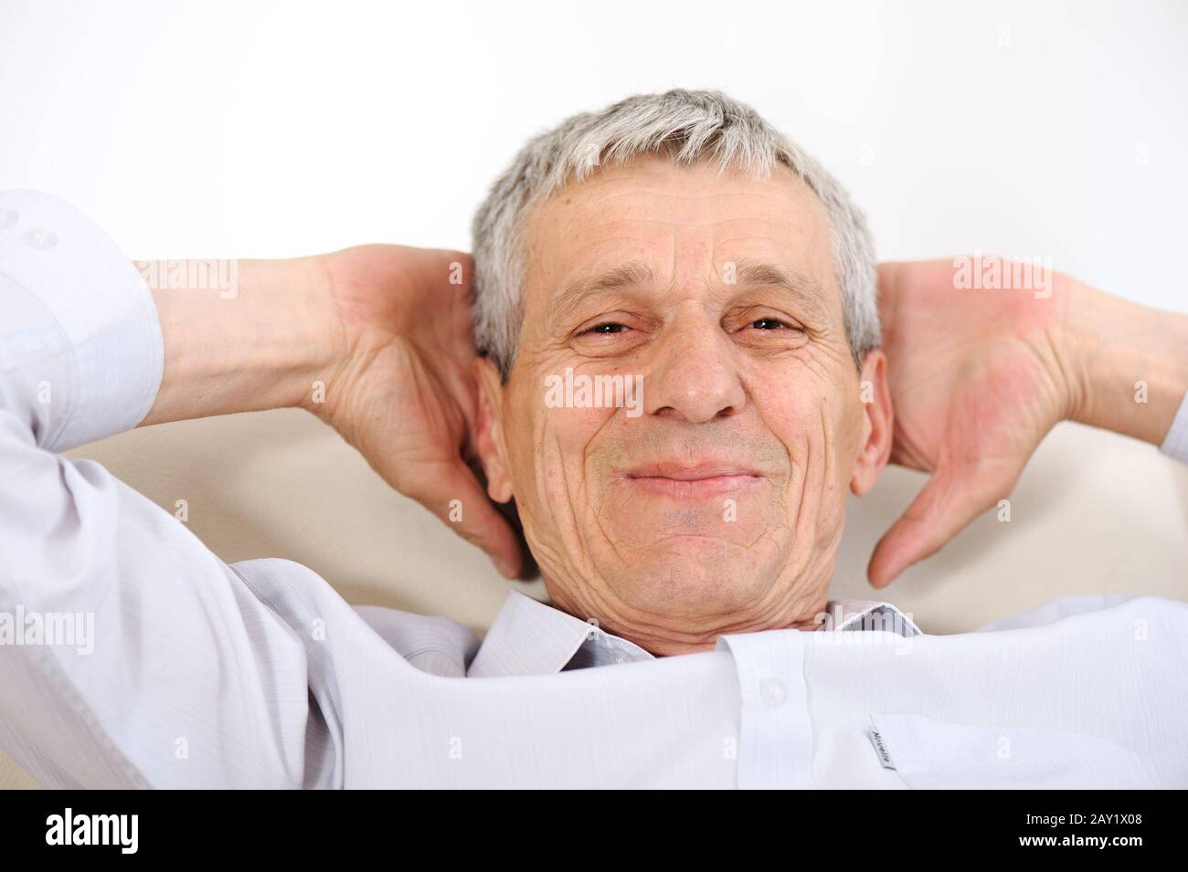 Happy relaxed elderly man at home Stock Photo