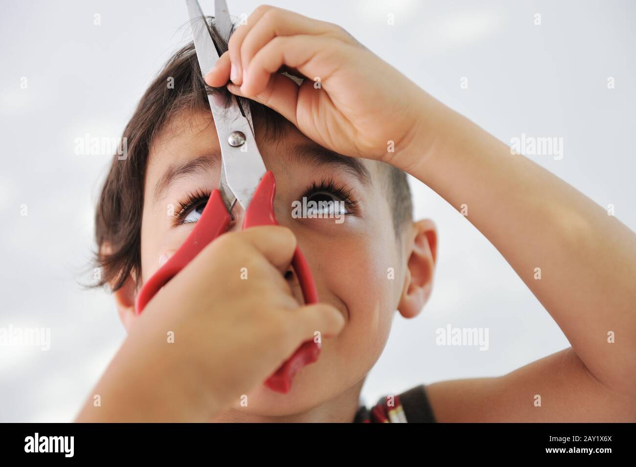Kids Using Razors Kid cutting hair to himself with scissors Stock Photo - Alamy