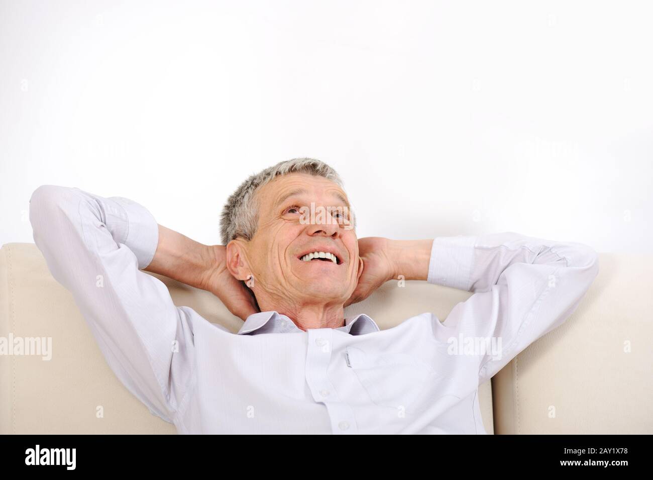 Happy relaxed elderly man at home Stock Photo