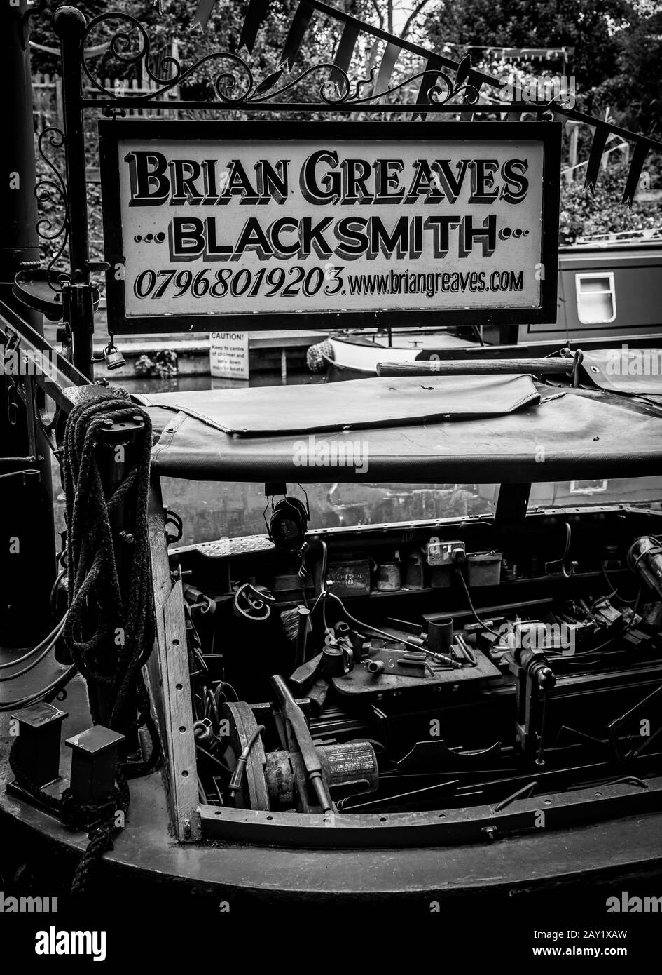 Black and white image of Brian Greaves Blacksmiths workshop on a  narrowboat moored in Gnosall, Staffordshire. Stock Photo