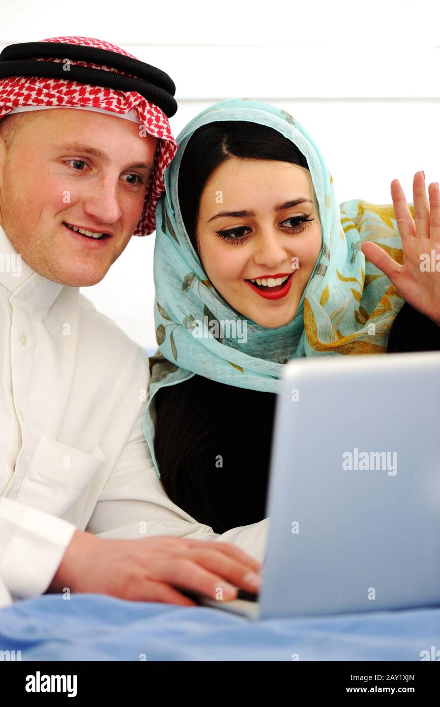 Arabic man and woman with laptop Stock Photo