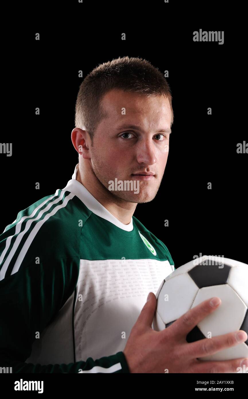Stock image of man holding soccer ball over dark background Stock Photo ...