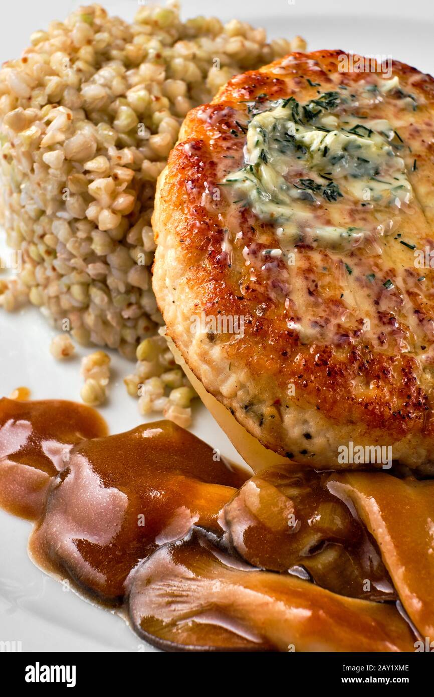 Close up view of meat cutlet with honey mushroom and green buckwheat Stock Photo