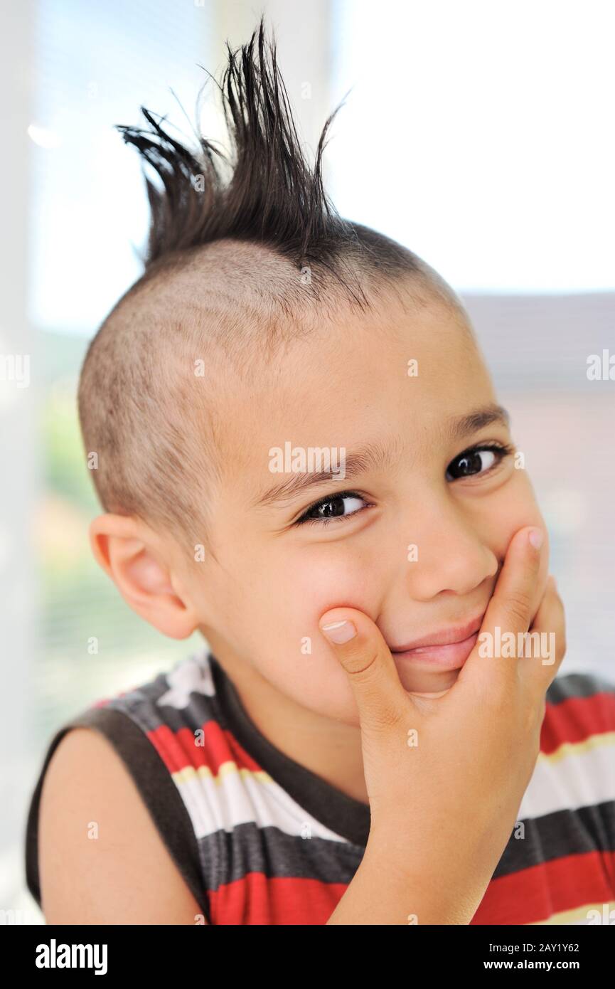 Cute little boy with funny hair and grimace Stock Photo - Alamy