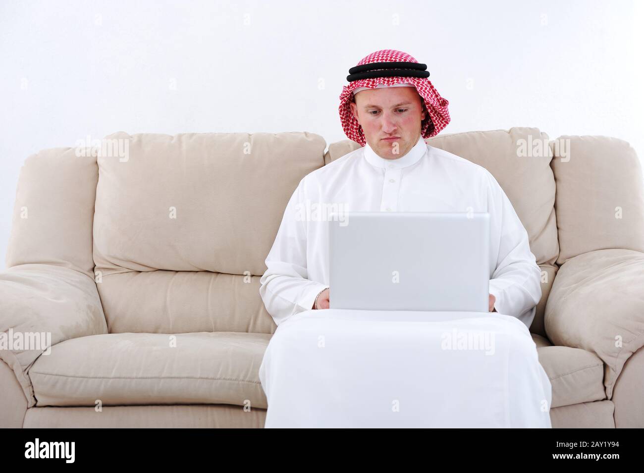 Arabic man using laptop at home Stock Photo