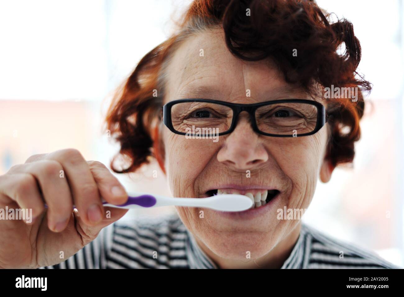 Senior woman brushing teeth Stock Photo