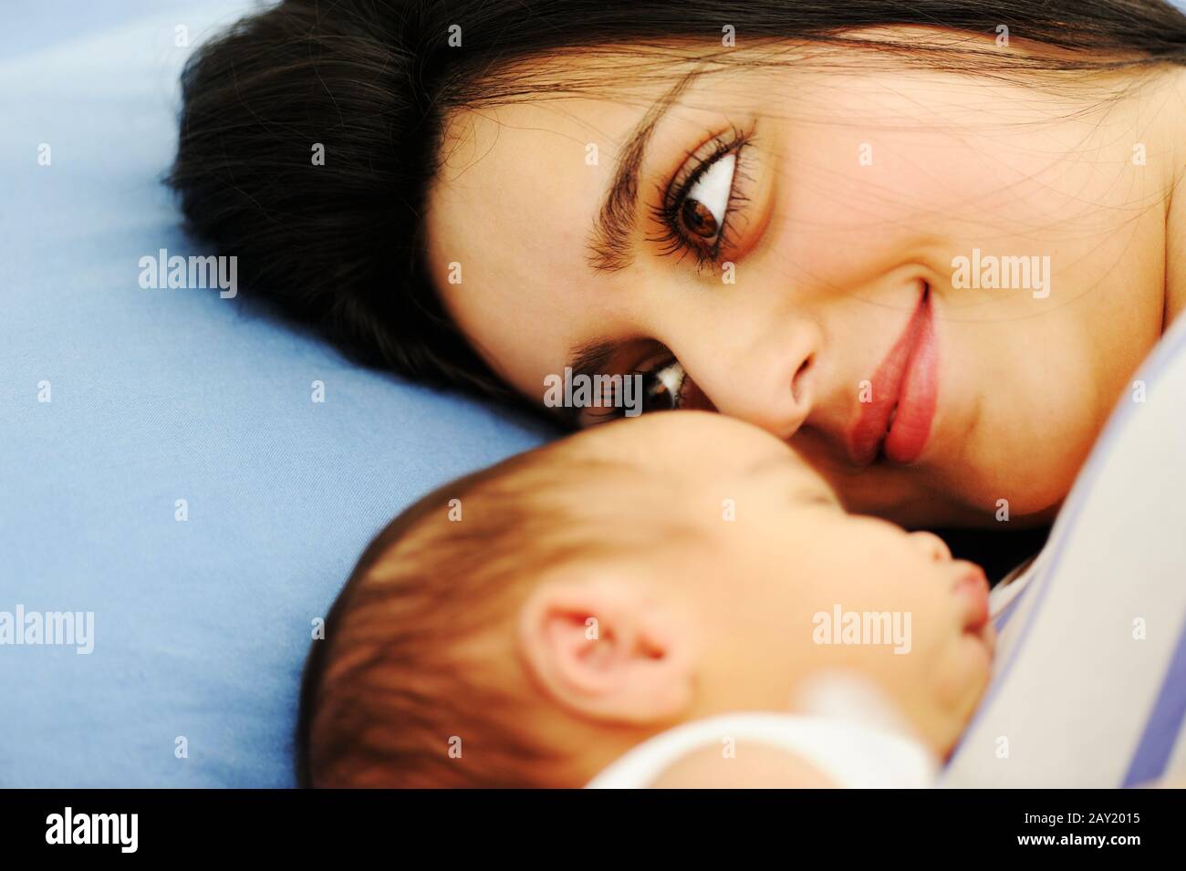 Woman holding her newborn baby at hospital Stock Photo