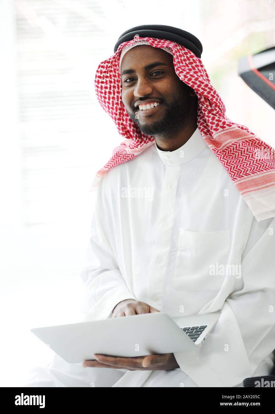 Black Arabic man working on laptop Stock Photo