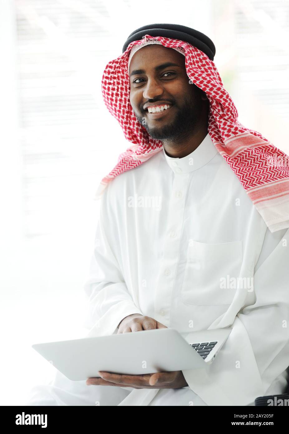 Black Arabic man working on laptop Stock Photo