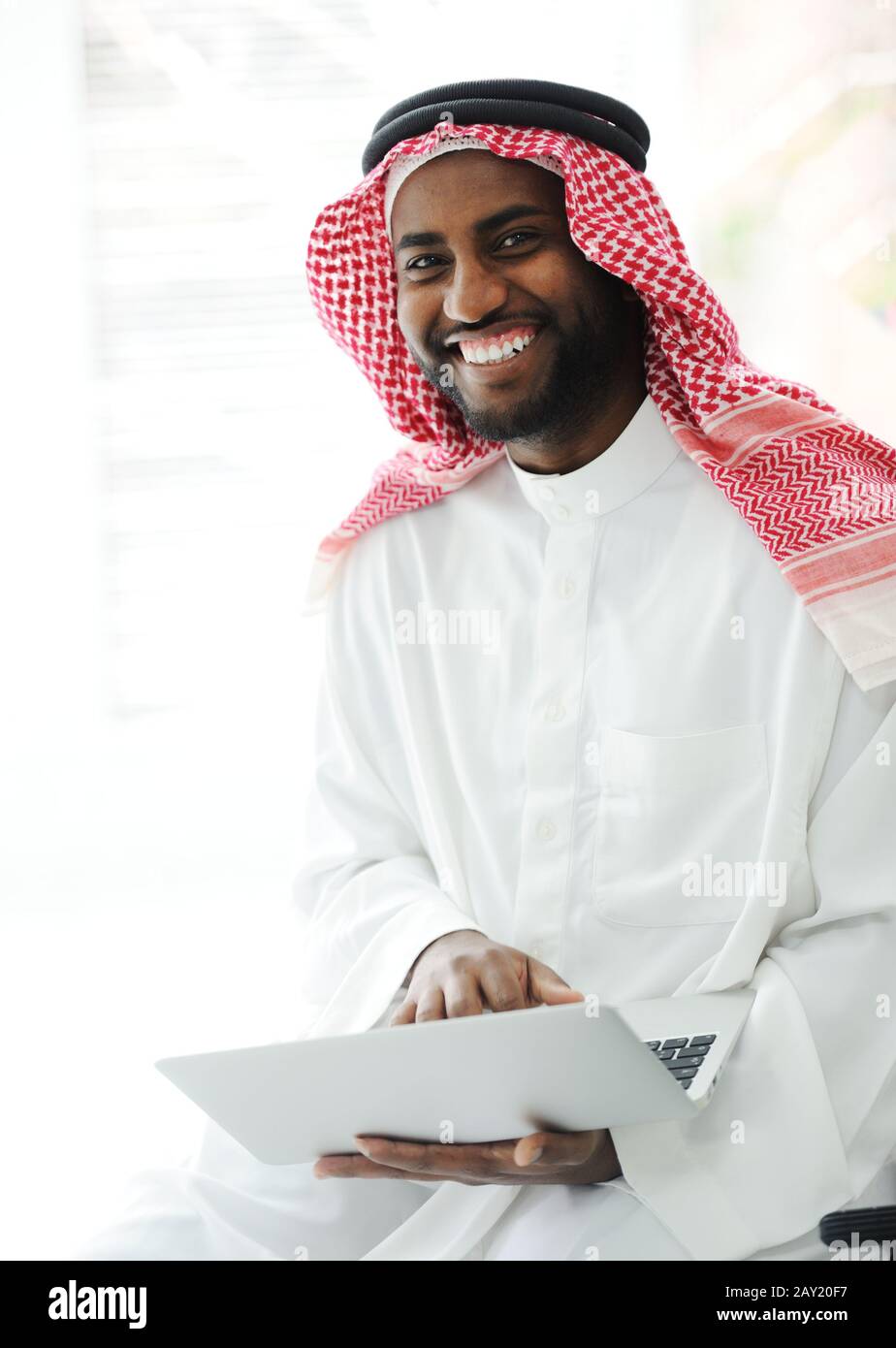 Black Arabic man working on laptop Stock Photo