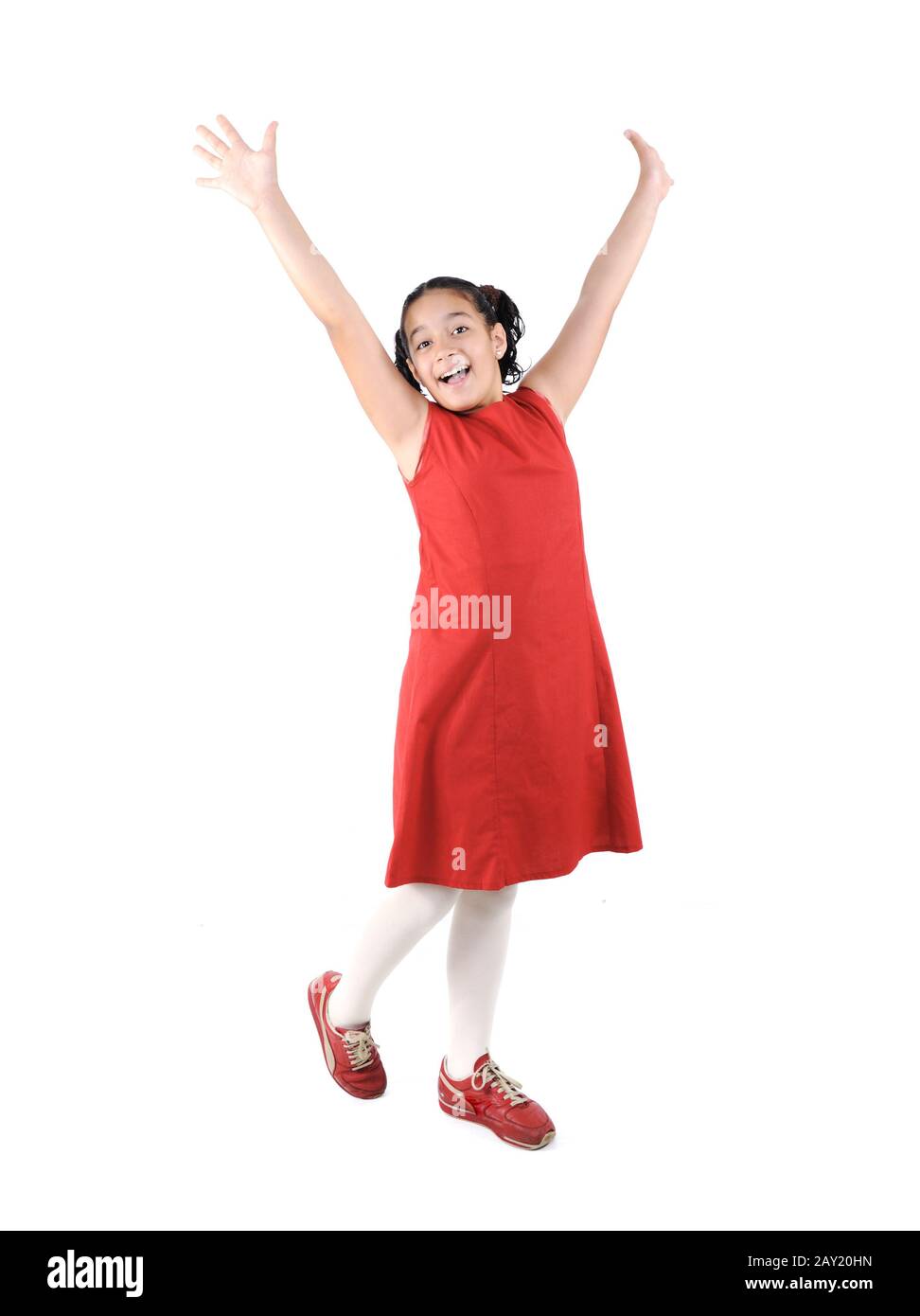 Adorable preteen school girl wearing red dress isolated Stock Photo - Alamy