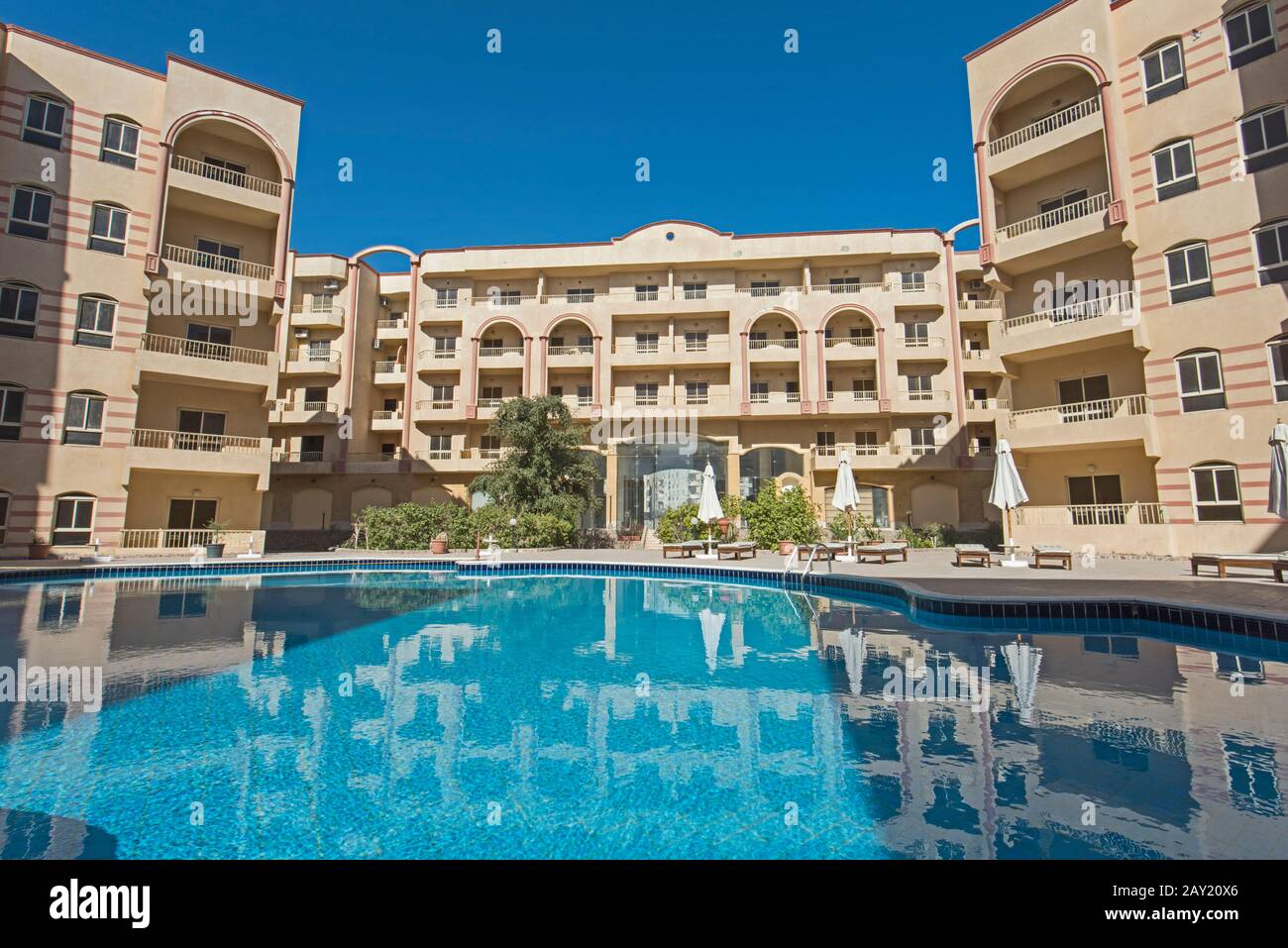 Large swimming pool with at a luxury tropical apartment resort complex Stock Photo