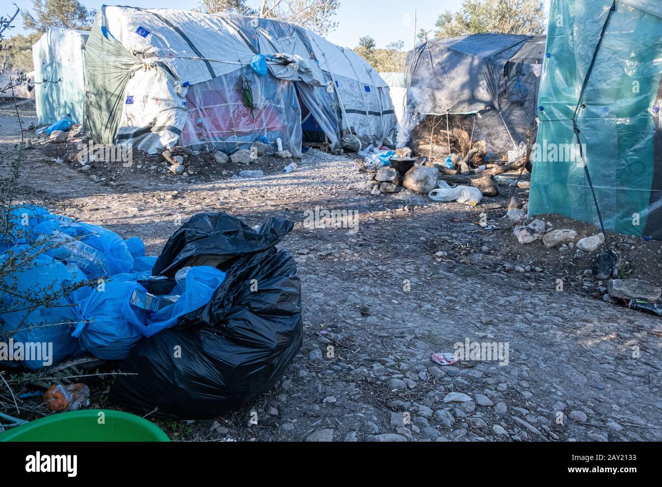 Cooking between the rubbish trash at Moria refugee camp Lesbos Stock Photo