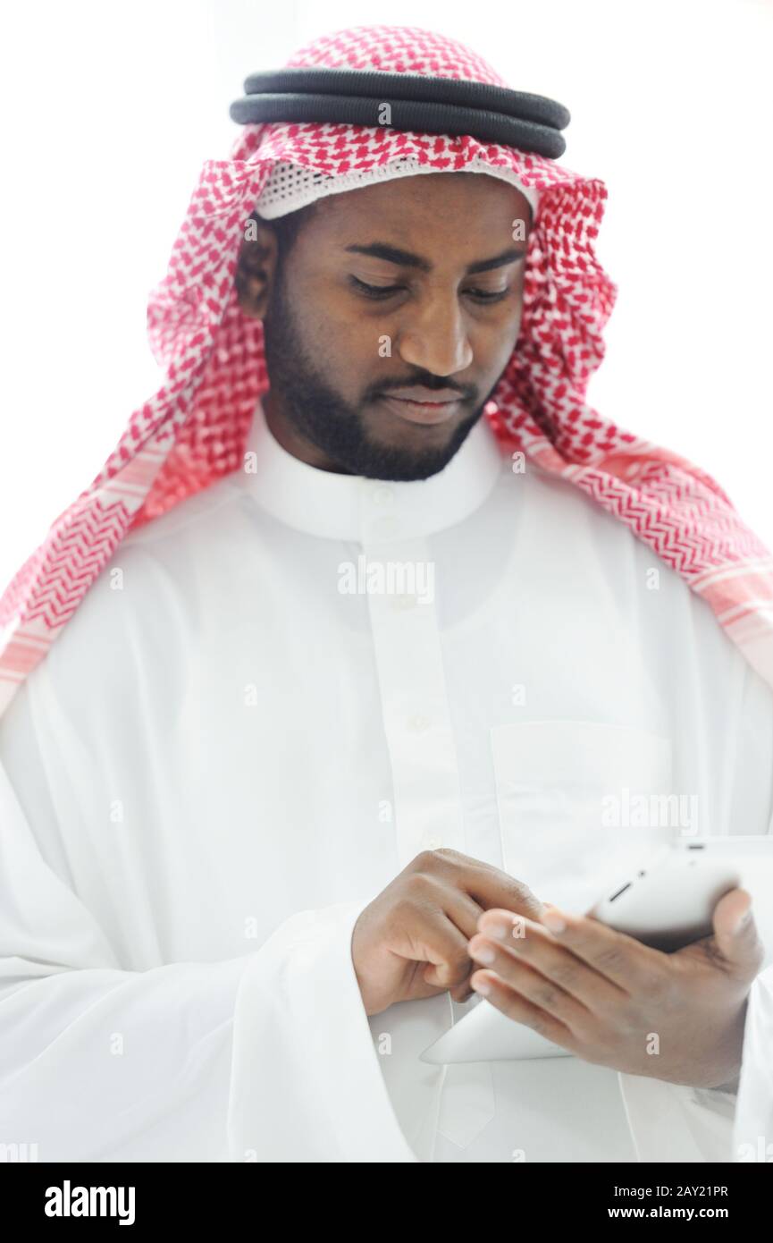 Middle eastern man with gulf clothes using tablet at office Stock Photo