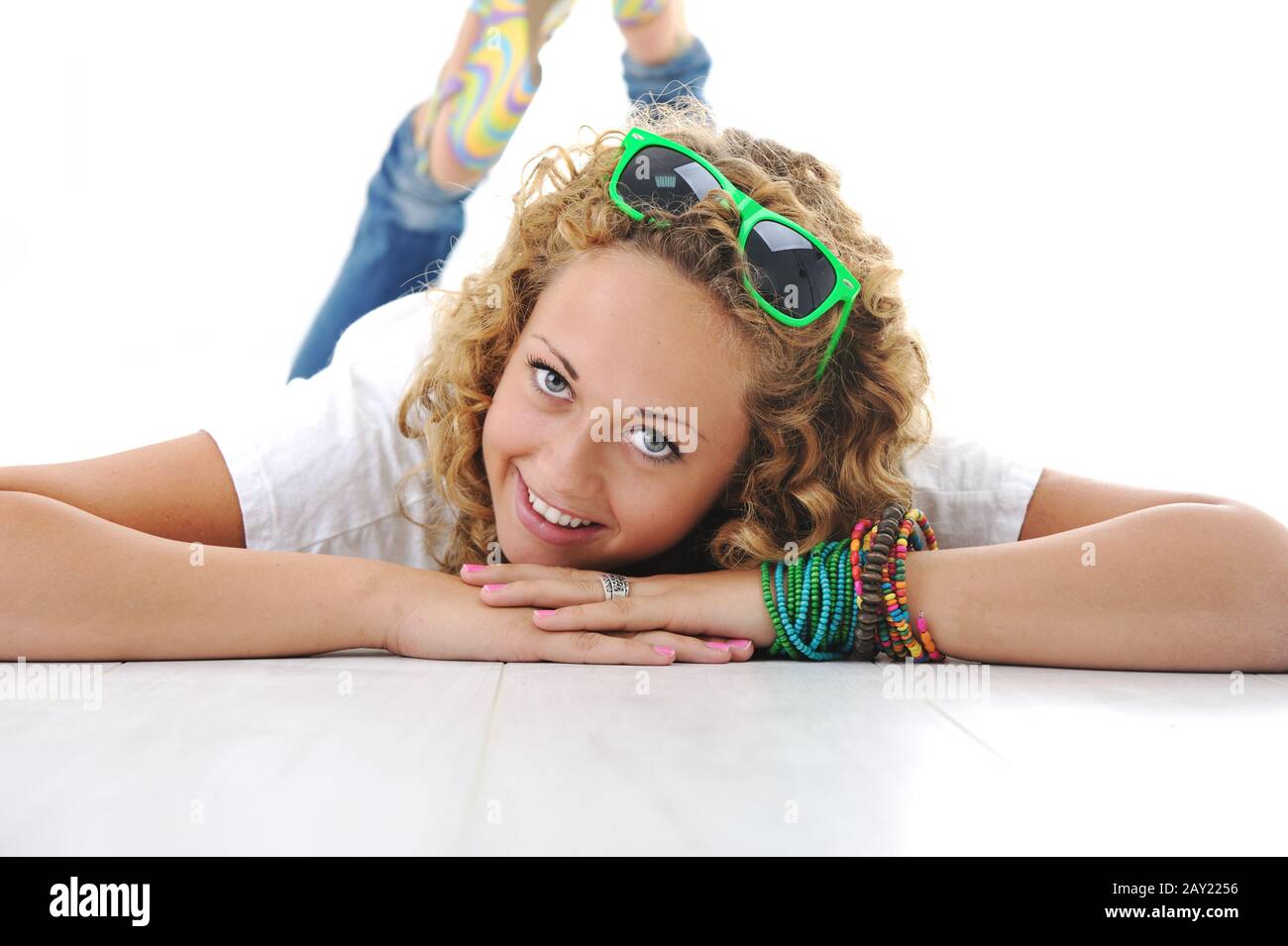 Young teen girl lying on floor Stock Photo - Alamy