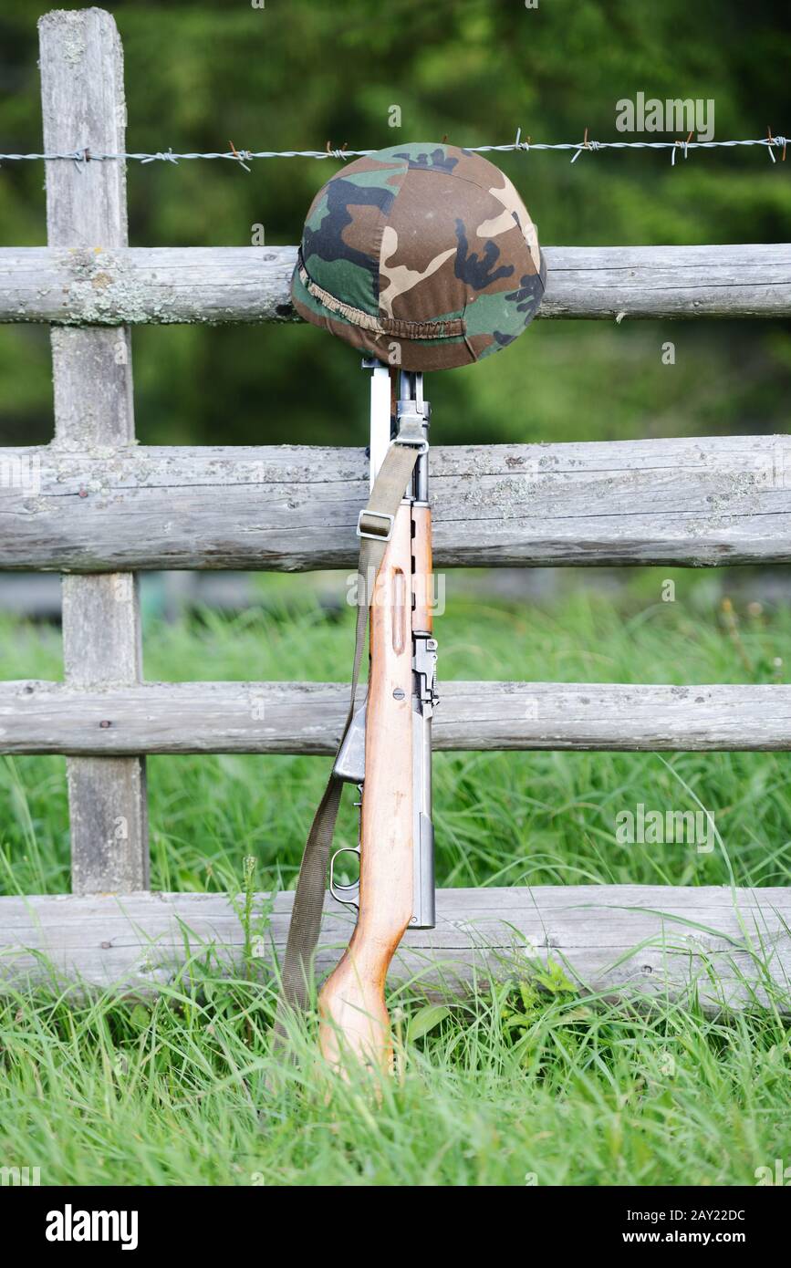 Military rifle and helmet Stock Photo