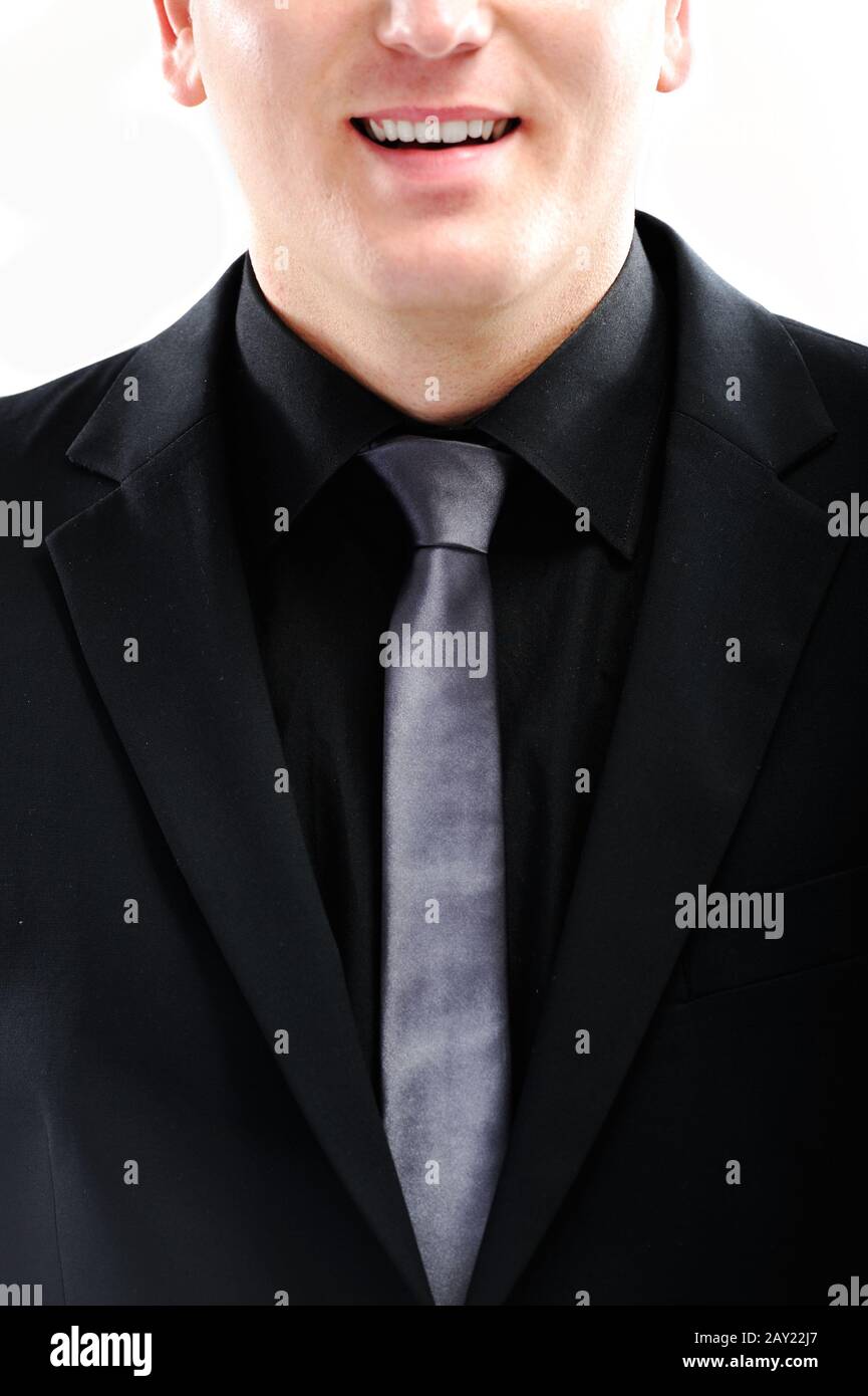Closeup image of a smiling guy in black suit Stock Photo