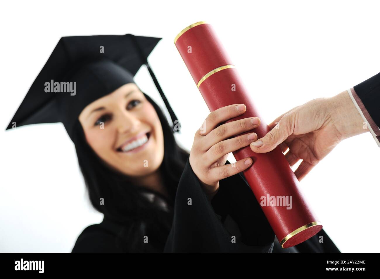 Graduate girl student in gown receiving diploma Stock Photo