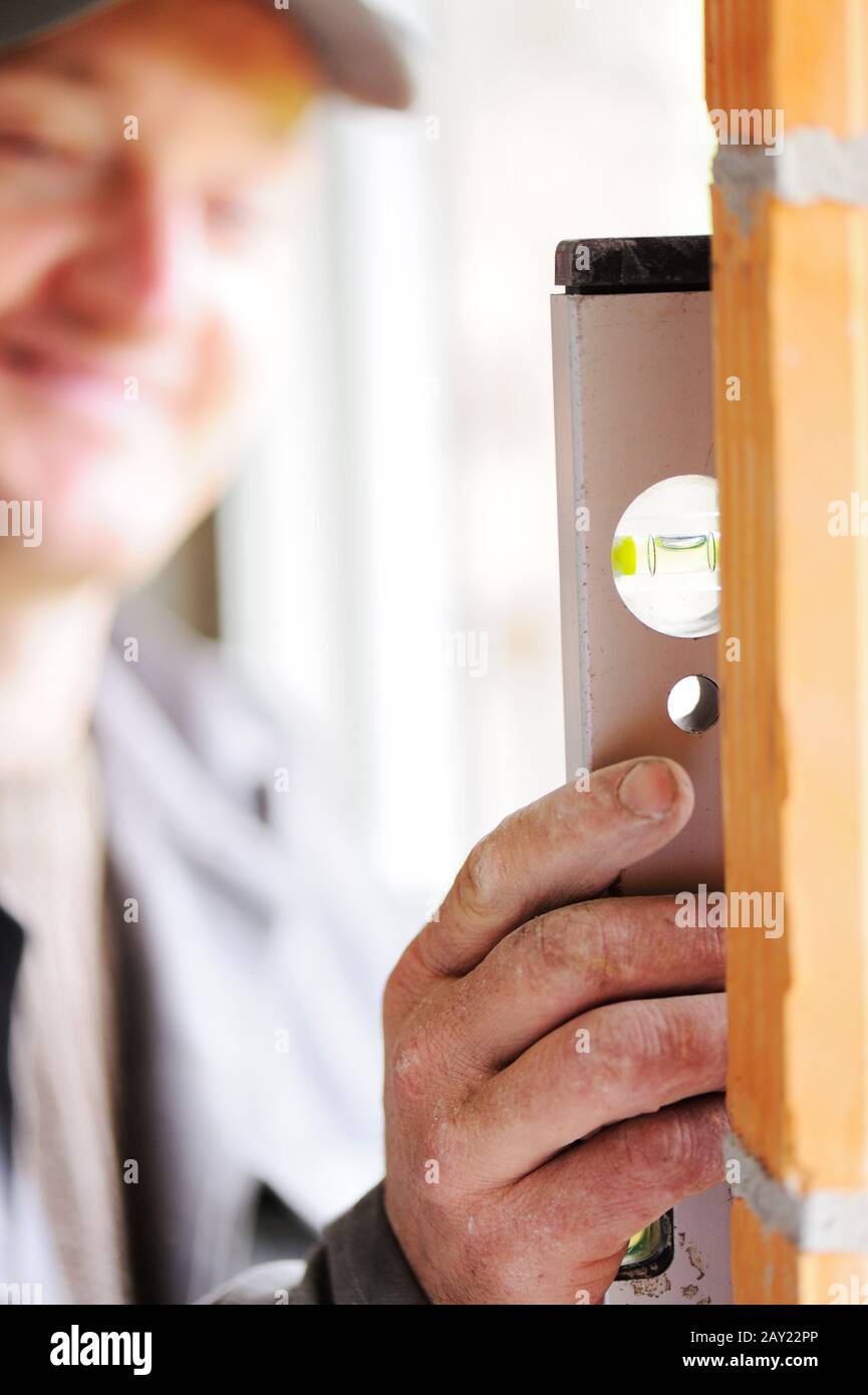 Construction worker with level tool Stock Photo
