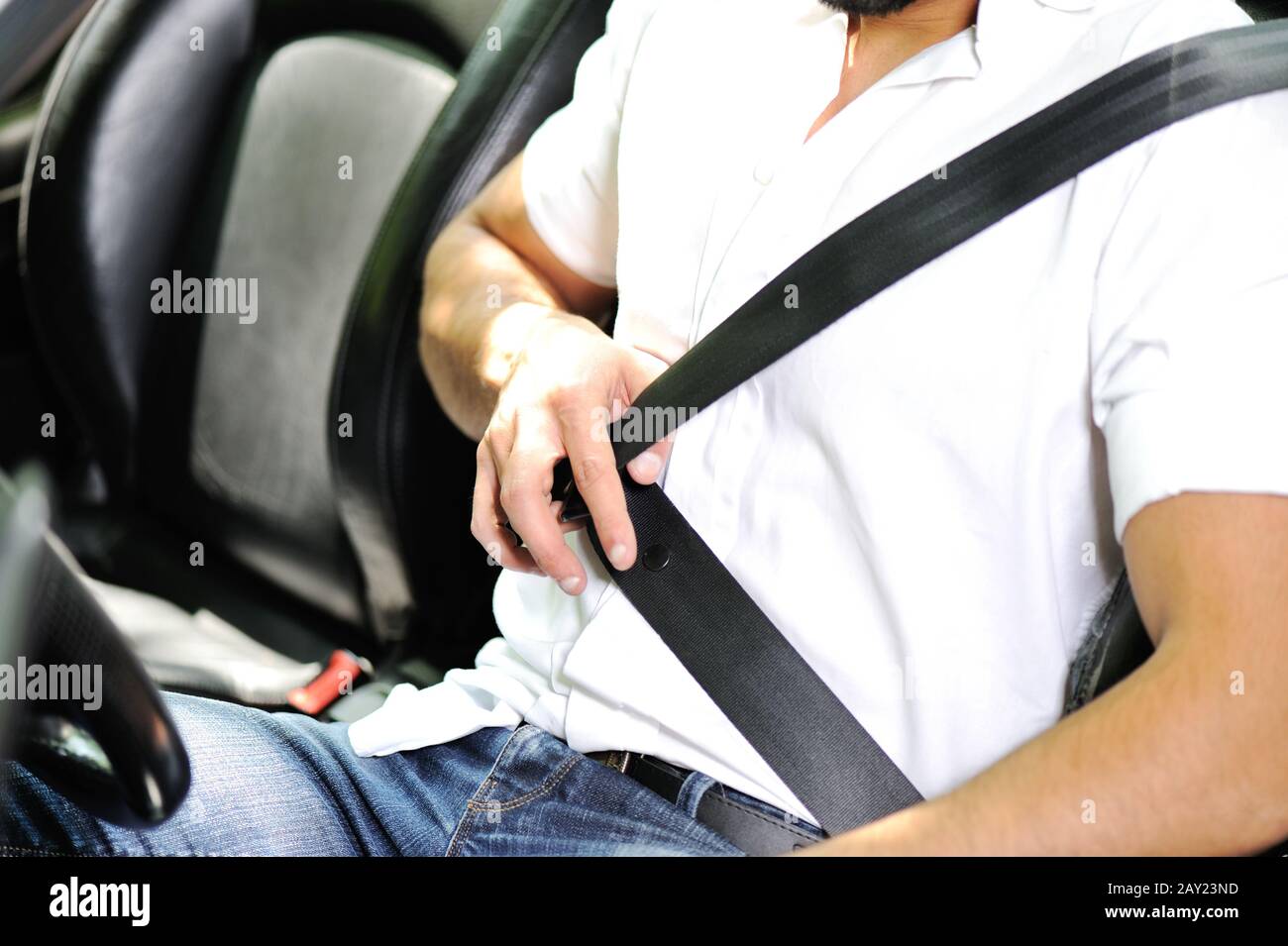 Man hand fastening a seat belt in the car Stock Photo