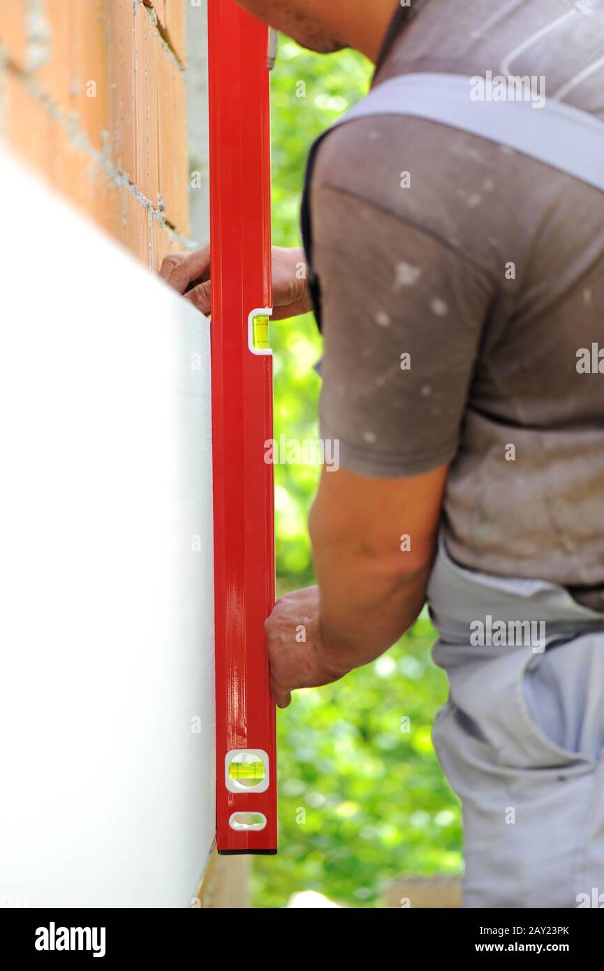 Construction worker using level tool Stock Photo