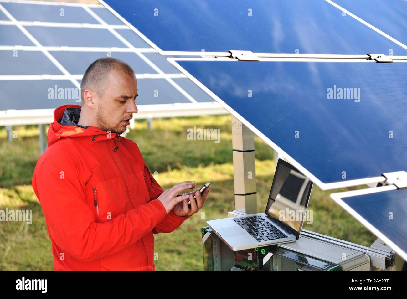 Engineer working with laptop by solar panels Stock Photo