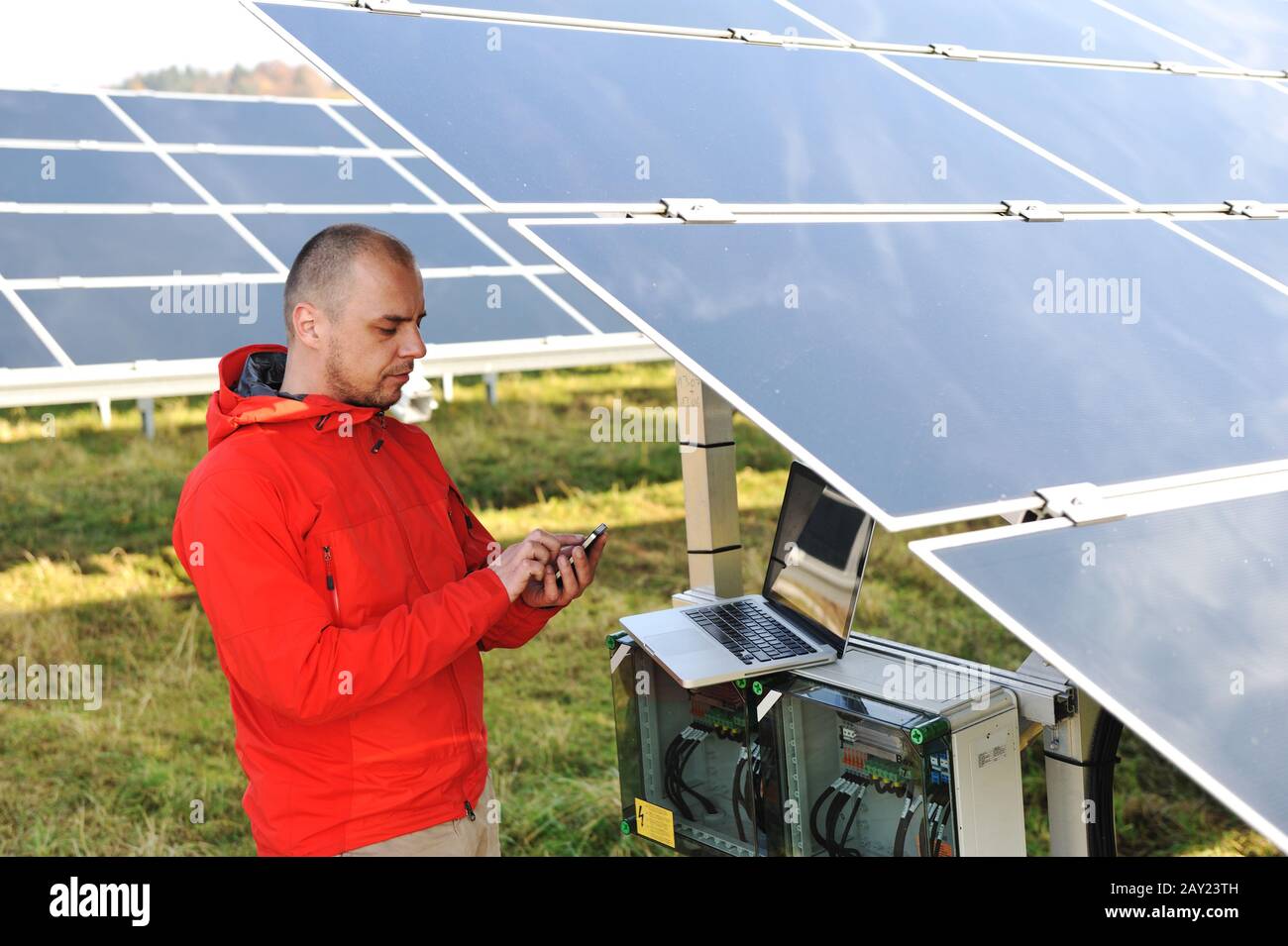 Engineer working with laptop by solar panels Stock Photo
