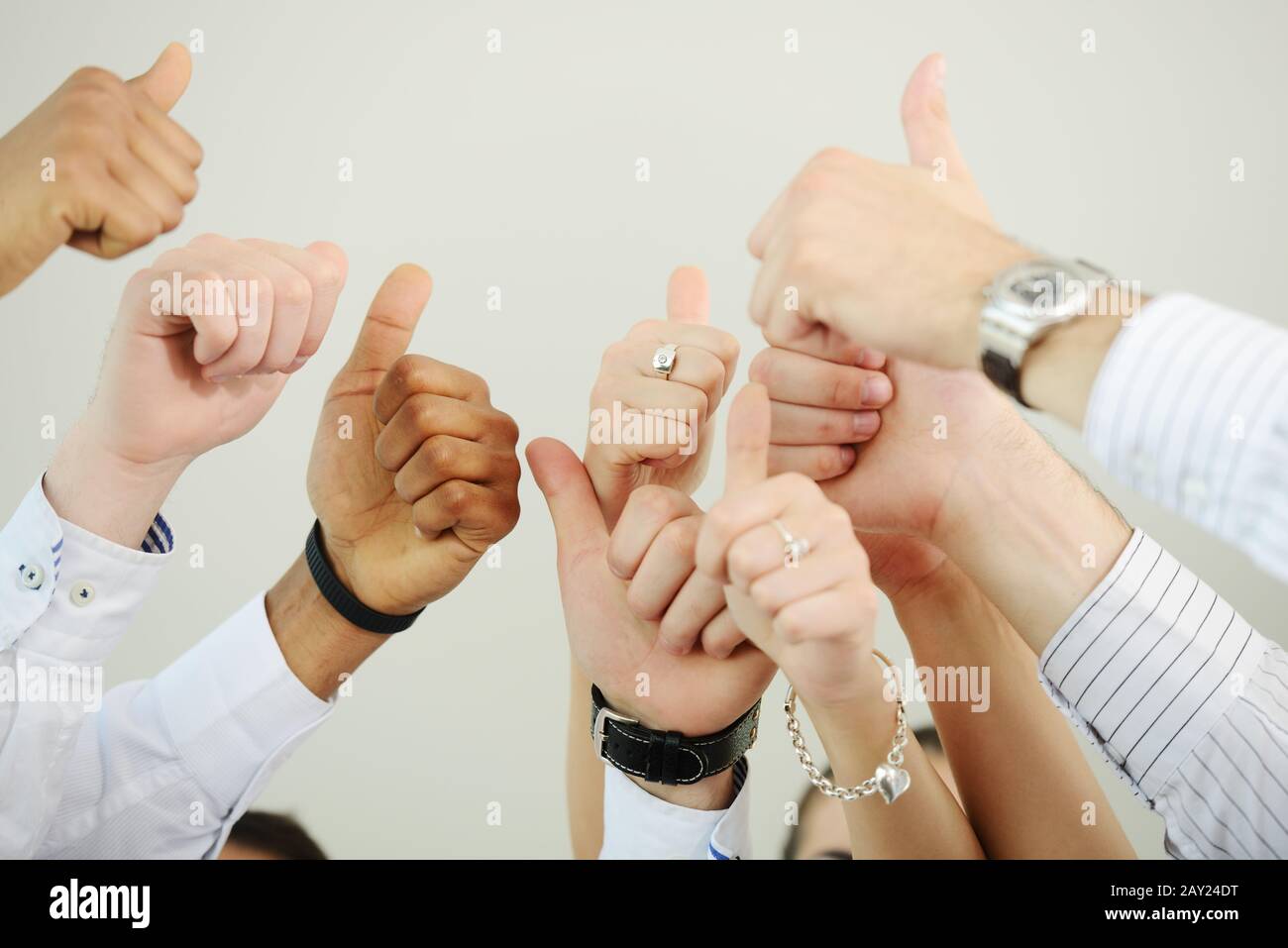 Successful business people with thumbs up Stock Photo - Alamy