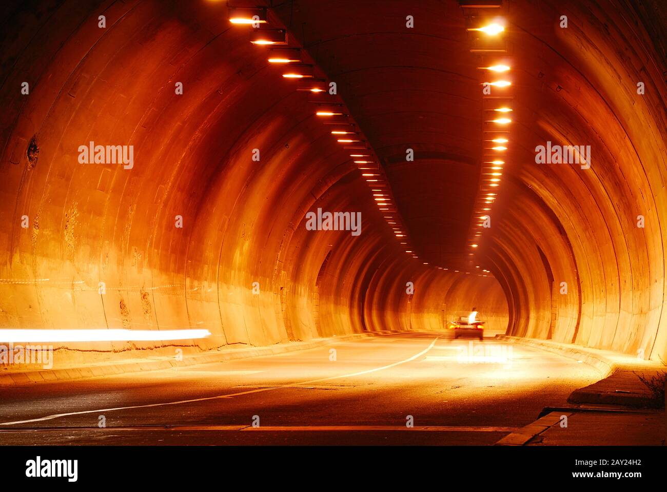 A tunnel in darknes with some lights Stock Photo