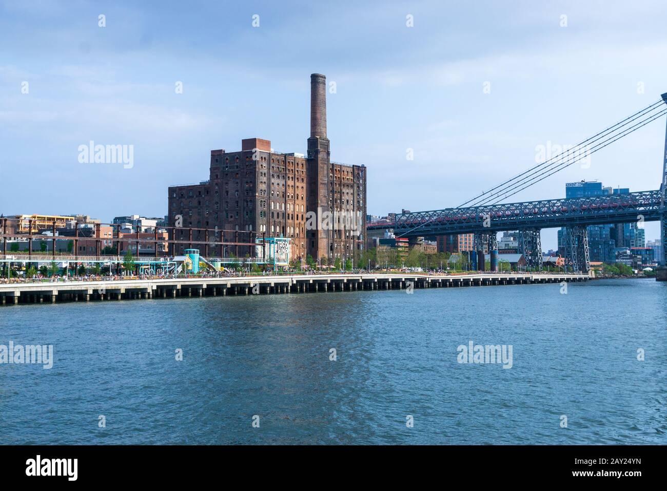 New York, USA - August 20, 2018: Domino Park, Old sugar factory and Williamsburg Bridge in Brooklyn, Williamsburg, New York City Stock Photo