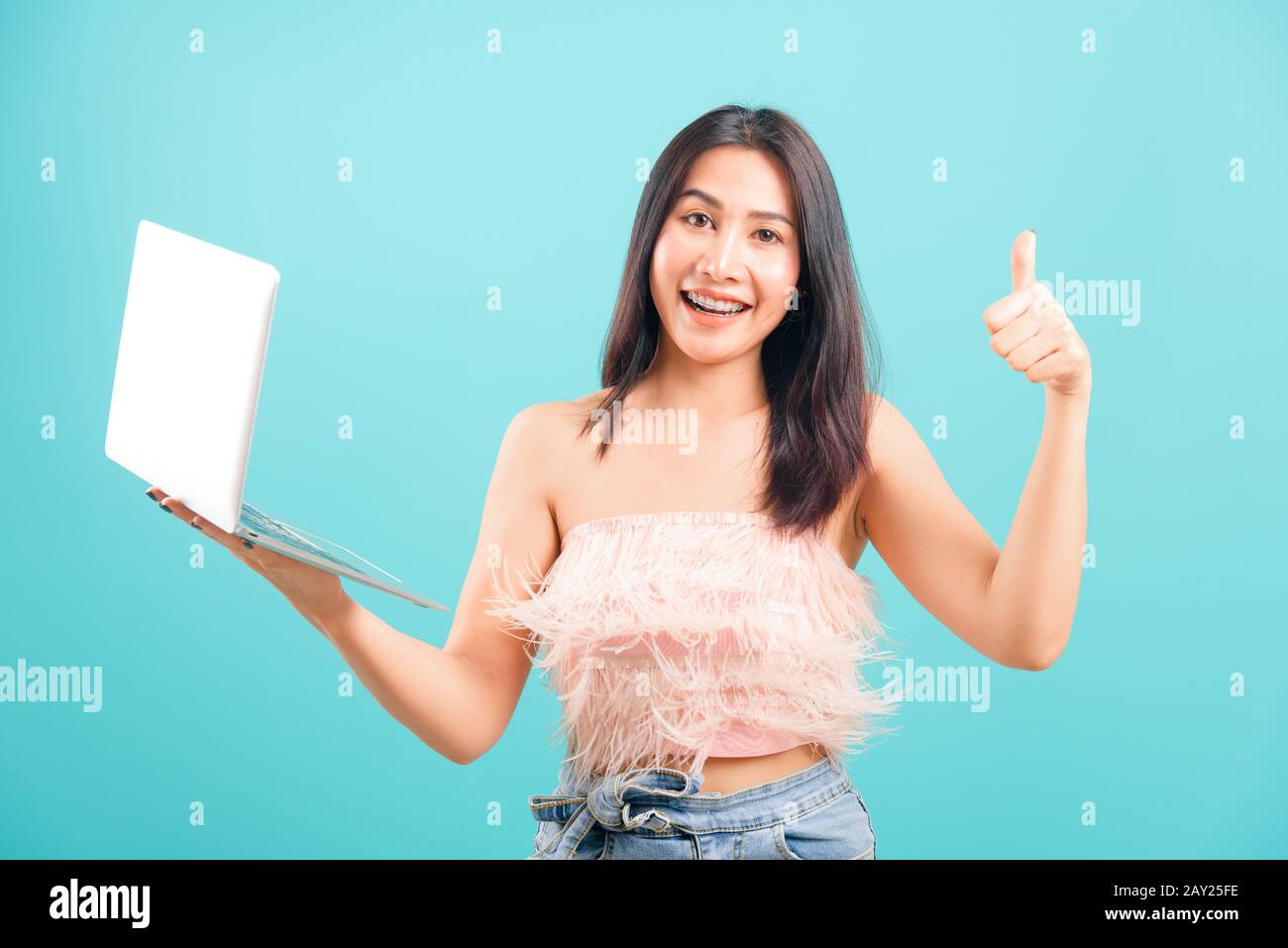 Smiling face portrait asian beautiful woman holding laptop computer and ...