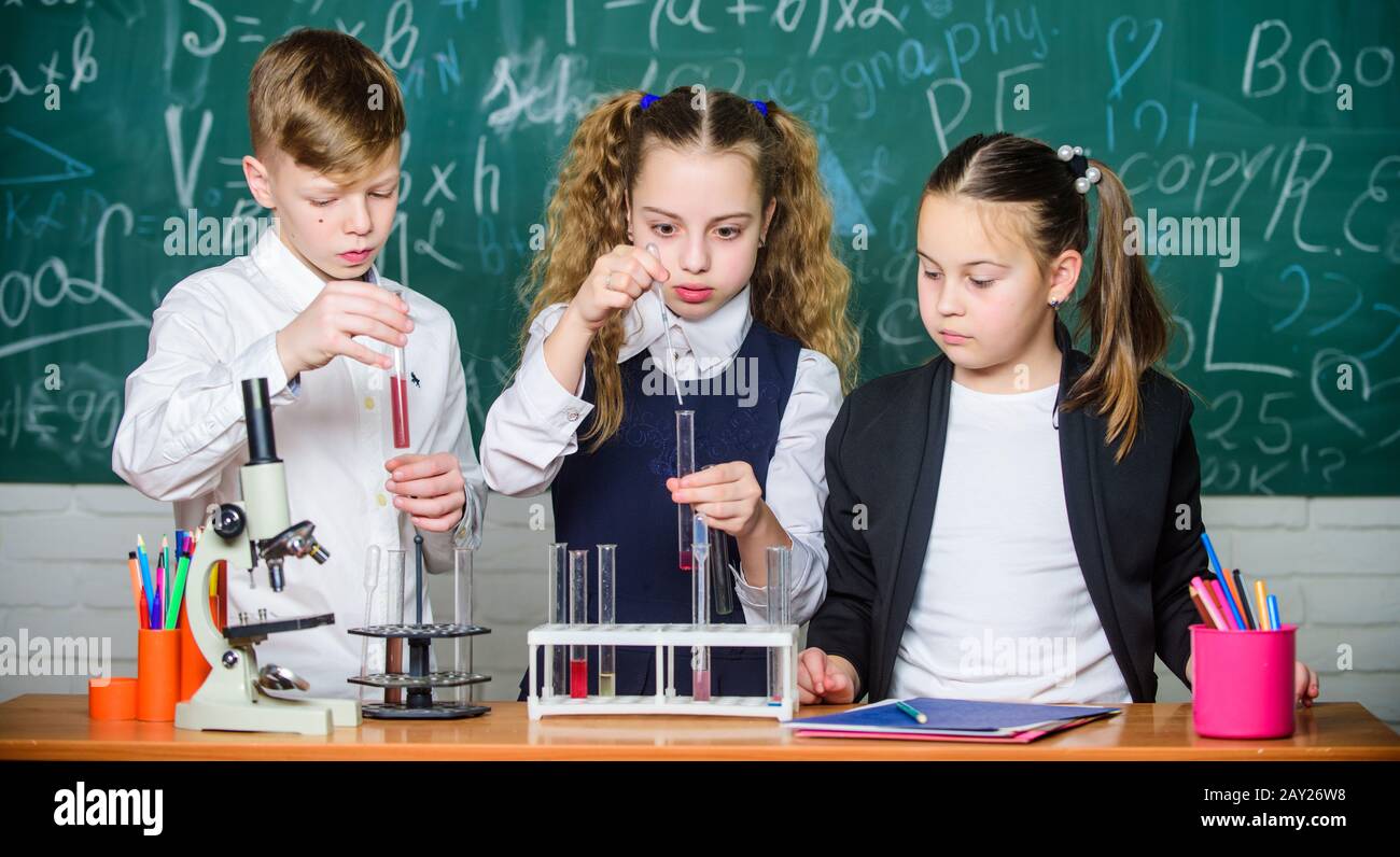Pupils study chemistry in school. Kids enjoy chemical experiment