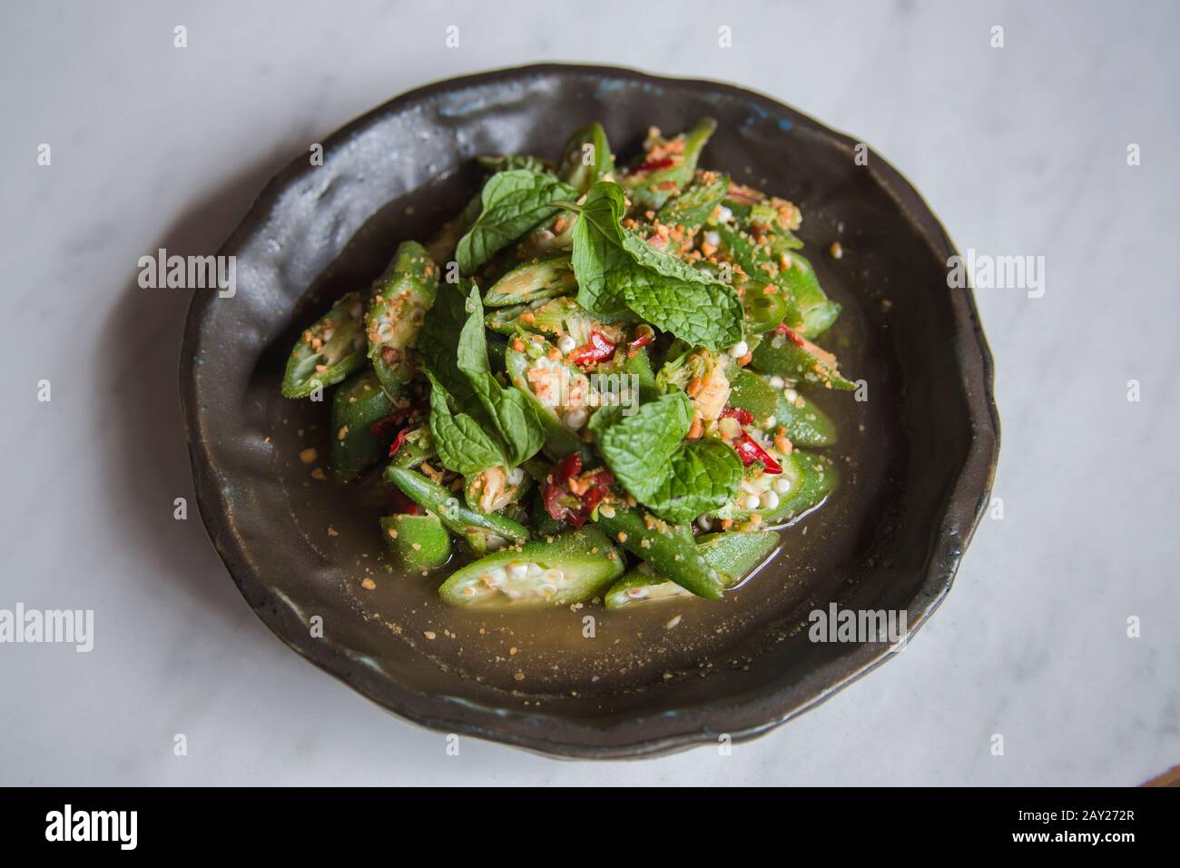 Thai food is  characterized by lightly prepared dishes with strong aromatic components and a spicy edge. This is stir fried Lady Finger 'Okra'. Stock Photo