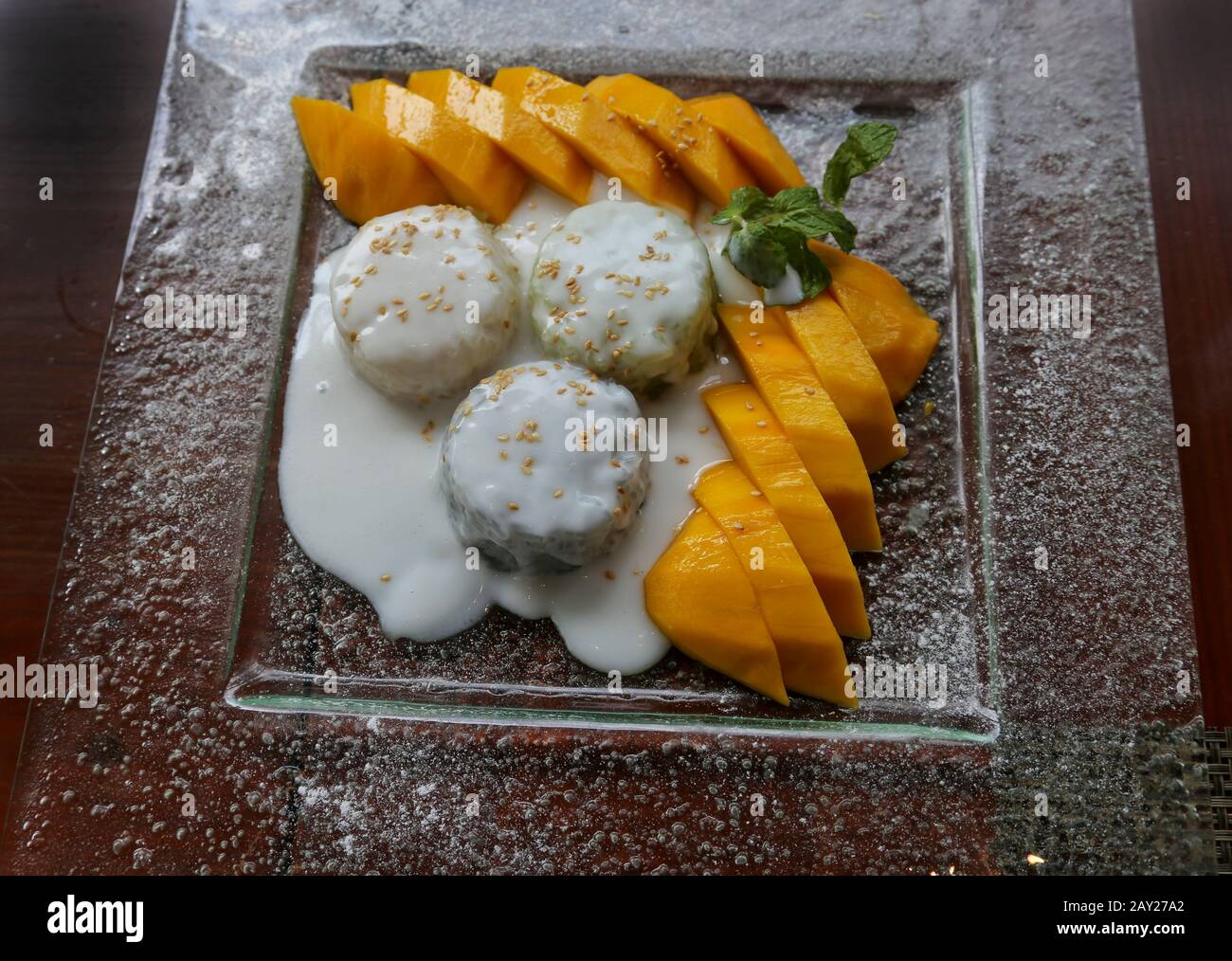 Thai food is  characterized by lightly prepared dishes with strong aromatic components and a spicy edge. Sticky Rice with Mango with Coconut Sauce. Stock Photo