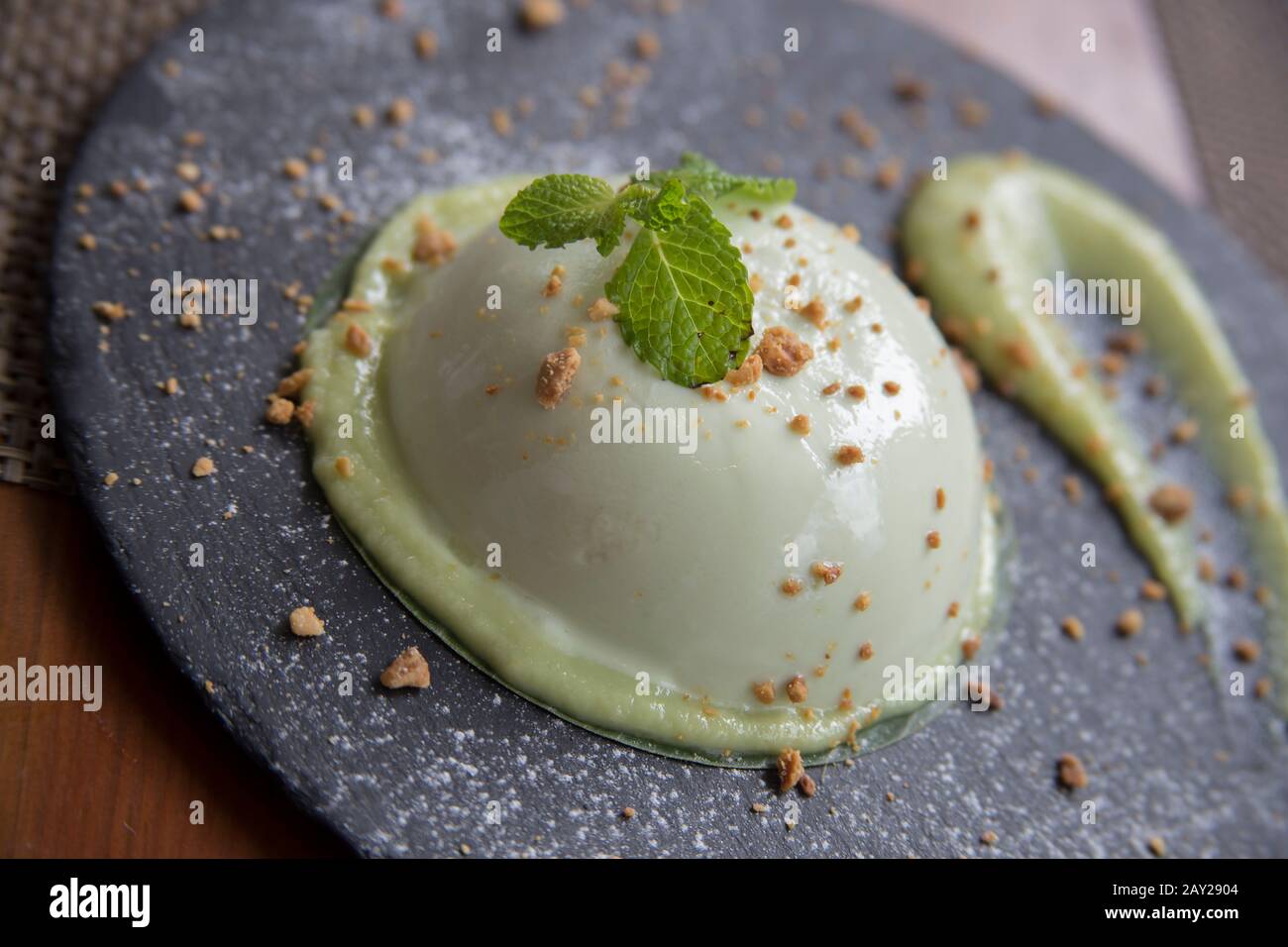 Thai food is  characterized by lightly prepared dishes with strong aromatic components and a spicy edge. This is an avocado panna cotta dessert, Stock Photo